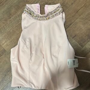 Women's sleeveless top with Embellished Neckline